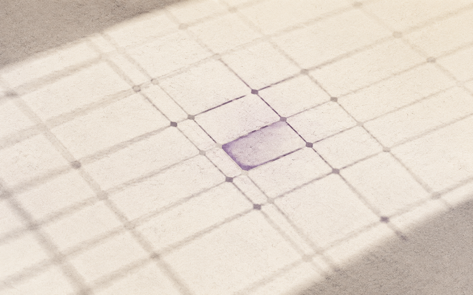 Abstract grid on textured paper with a diagonal beam of light and a highlighted cell